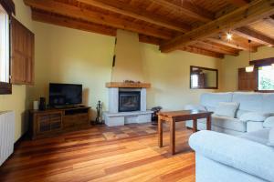 a living room with a couch and a fireplace at Complejo Rural La Venta Vieja by CABANA Rentals in Ortigosa del Monte