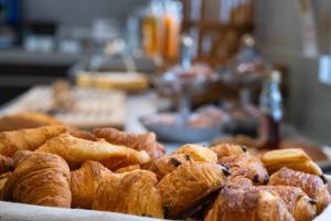 a pile of pastries sitting on a table at LOGIS Hôtel de Bourgogne - Mâcon in Mâcon