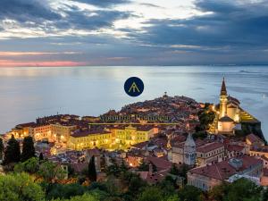 a view of a city with the nordicaordigationigation logo on top at Apartma Piranesa III in Piran