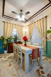 a dining room with a white table and chairs at Christmas Ready Villa with Outdoor Cinema and Bonfire 7 mins to Calle Crisologo in Vigan