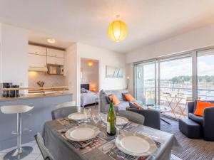 a kitchen and living room with a table and chairs at Charmant T2 avec vue port, idéal pour 4 pers. à La Trinité-sur-Mer - FR-1-477-78 in La Trinité-sur-Mer