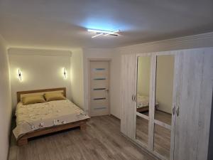 a bedroom with a bed and a ceiling fan at Buiucani in Chişinău