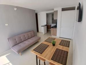 a living room with a couch and a table at Five Homes Ricaurte in Ricaurte