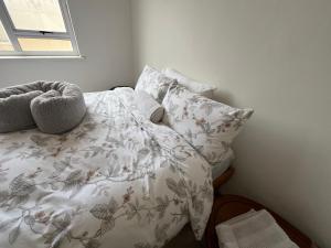 a bedroom with a bed with a blanket and pillows at By the Sea in Swakopmund