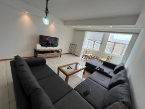 a living room with a couch and a tv at By the Sea in Swakopmund +20 photos