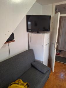 a living room with a couch and a flat screen tv at Aca's & Lidija's Thermal Hideaway Čatež - Tickets included in Brežice