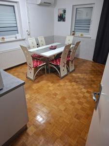 a table and chairs in a room with a kitchen at Aca's & Lidija's Thermal Hideaway Čatež - Tickets included in Brežice +4 photos