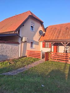 a house with an orange roof and a fence at Aca's & Lidija's Thermal Hideaway Čatež - Tickets included in Brežice