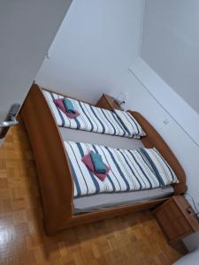 two beds with pillows on them in a room at Aca's & Lidija's Thermal Hideaway Čatež - Tickets included in Brežice