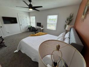 a living room with a bed and a ceiling fan at Azalea: 2 primary bedrooms w/ bathrooms in Augusta
