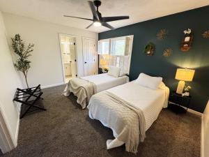 a bedroom with two beds and a ceiling fan at Azalea: 2 primary bedrooms w/ bathrooms in Augusta