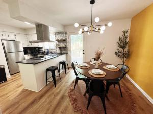 a kitchen and dining room with a table and chairs at Azalea: 2 primary bedrooms w/ bathrooms in Augusta