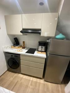 a small kitchen with a stove and a refrigerator at L'horizon De Coursan in Coursan +22 photos