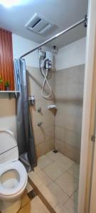 a bathroom with a shower and a toilet at Condo in Silang near Nuvali - Dy's Haven Suites in Silang