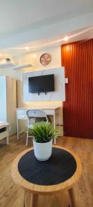 a room with a table with a potted plant on it at Condo in Silang near Nuvali - Dy's Haven Suites in Silang