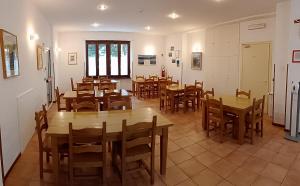 a dining room with wooden tables and chairs at Casa San Francesco in Bardonecchia