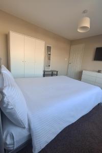 a bedroom with a large white bed and a table at City Stays Norwich NR3 in NWI