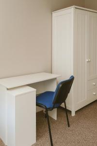 a white desk and a blue chair in a room at City Stays Norwich NR3 in NWI +3 photos