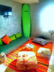 a room with a bed with a surfboard on the wall at Villa Rabia in Sidi Kaouki