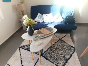 a living room with a blue couch and a table at T2 a St Nazaire, 500 mètres de la plage in Saint-Nazaire