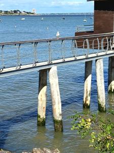 a bridge over the water with a bird on it at T2 a St Nazaire, 500 mètres de la plage in Saint-Nazaire +8 photos