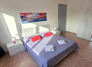 a bedroom with a large bed with two red pillows at Home Lazio 36 in Cosenza