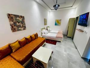 a living room with a couch and a bed at Hotel Cecil in Marrakech