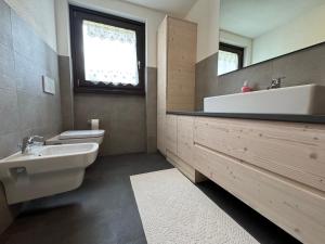 a bathroom with a sink and a toilet and a mirror at Suite Panorama in Valdisotto +7 photos