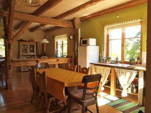 a kitchen and dining room with a table and chairs at U Górali in Jagniątków