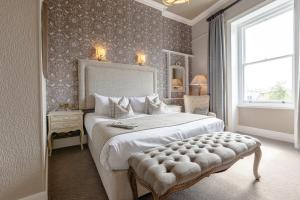 a bedroom with a large bed and a window at The Royal Hotel in Bideford