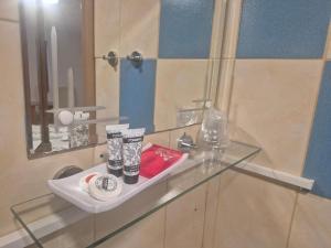 a glass counter in a bathroom with a mirror at Vila Paula & SPA -ALL INCLUSIVE in Sovata +29 photos