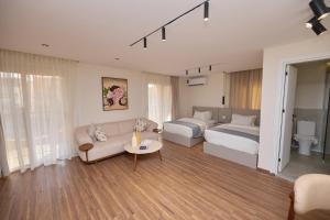 a living room with a bed and a couch and a bedroom at Settle inn Fajr Boutique hotel in Cairo