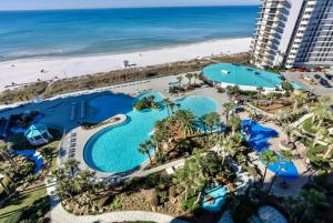 an aerial view of a resort with a swimming pool and the beach at Mermaid's Den in Panama City Beach