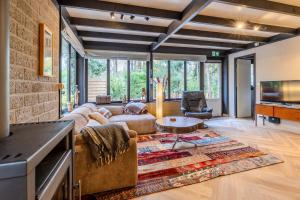 a living room with a couch and a table at Lux Bos Chalet in Lanaken