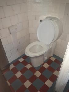a bathroom with a white toilet in a room at Paloma in Atlántida