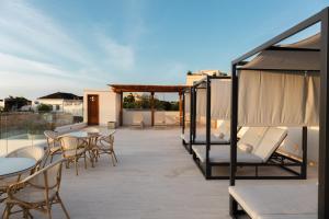 a patio with tables and chairs on a roof at Hotel Palacio del Agua by Faranda Boutique in Cartagena de Indias