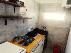 Colonia ChapadmalalにあるSal y Arenaの小さなキッチン(シンク付)、窓 +2枚の写真