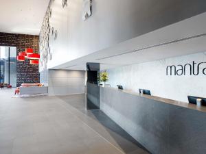 a lobby with a martini sign on the wall at Mantra Circle On Cavill in Gold Coast +79 photos