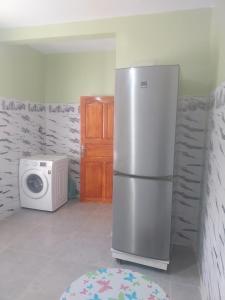 a kitchen with a refrigerator and a microwave at Berber Family 