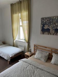 a bedroom with two beds and a window at Apartmán Ekonomy 