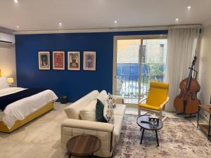 a bedroom with a bed and a living room with a guitar at فلل الخالدية in Jeddah +49 photos