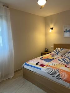 a bedroom with a bed and a window at l'appart' in Marseille
