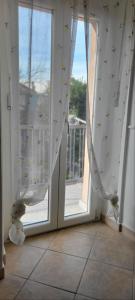 a room with a window with curtains and a door at Casa Bomba in San Mauro Torinese