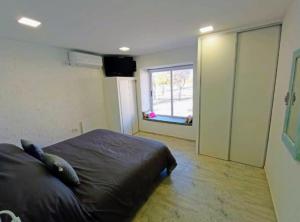 a bedroom with a large bed and a window at Atardeceres del dique in Cortaderas
