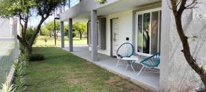 two chairs sitting on the porch of a house at Atardeceres del dique in Cortaderas