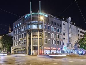 a large building on a city street at night at Hotel Wendelstein München City in Munich