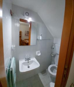 a bathroom with a sink and a toilet at Casa Licia Sorso in Marina di Sorso