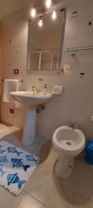 a bathroom with a sink and a toilet at Casa Licia Sorso in Marina di Sorso