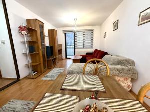 a living room with a couch and a table at Adela Mountain View Sinaia in Sinaia