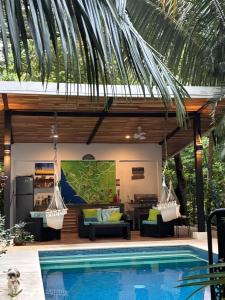 a villa with a swimming pool and a house at Casitas Escondidas in Playa Pelada